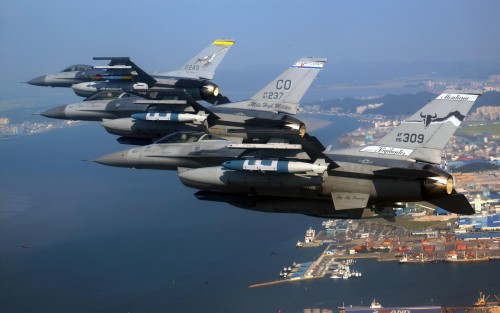 A three-ship formation of Air National Guard F-16 Fighting Falcons flies over Kunsan City, South Kor