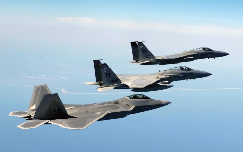 OVER THE ATLANTIC OCEAN -- An F/A-22 Raptor, foreground, flies in formation with two F-15 Eagles en 