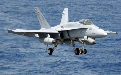 An F/A-18C Hornet from the Strike Fighter Squadron 83 prepares to land on the flight deck of the Nim