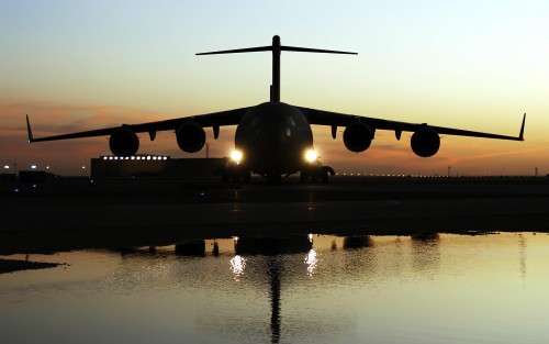 Crewmembers aboard a C-17 Globemaster III aircraft prepare to offload wounded personnel from Balad A