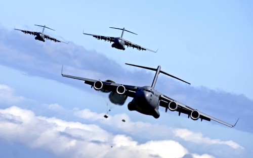 Heavy equipment pallets fall from C-17 Globemaster IIIs May 16, 2006, during an airdrop training mis